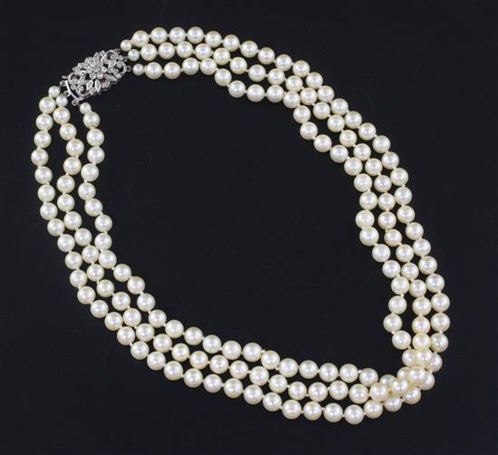 A triple strand cultured pearl choker necklace with 9ct white gold and diamond cluster clasp, 41cm.